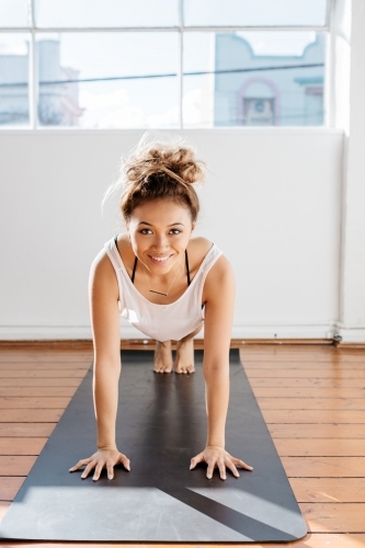 Happy girl working out in the gym studio - Australian Stock Image