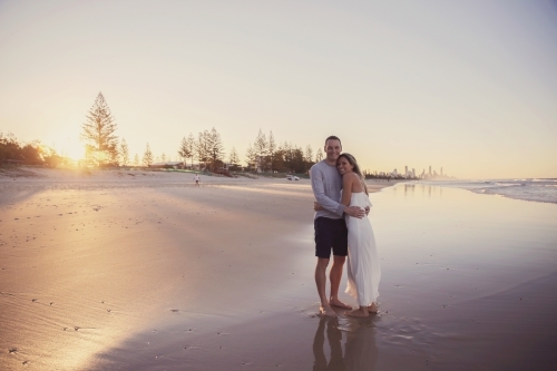 Happy mature couple on the beach at sunset - Australian Stock Image