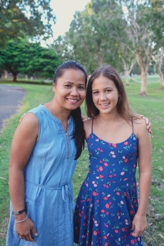 Happy multicultural mother and daughter in the park - Australian Stock Image