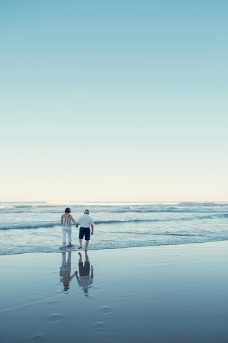 Happy multicultural senior couple on the beach - Australian Stock Image