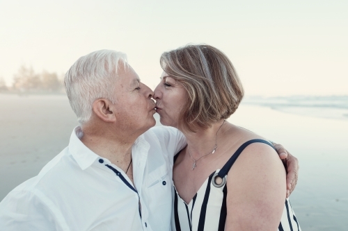 Happy multicultural senior couple on the beach - Australian Stock Image