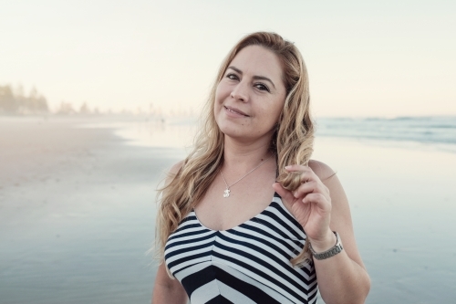 Happy multicultural woman on the beach - Australian Stock Image