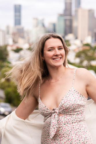 happy natural 24 year old woman on a suburban street - Australian Stock Image