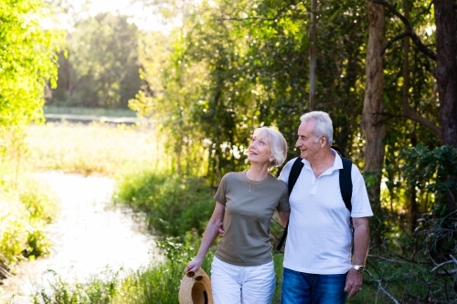 happy senior couple on a nature walk - Australian Stock Image