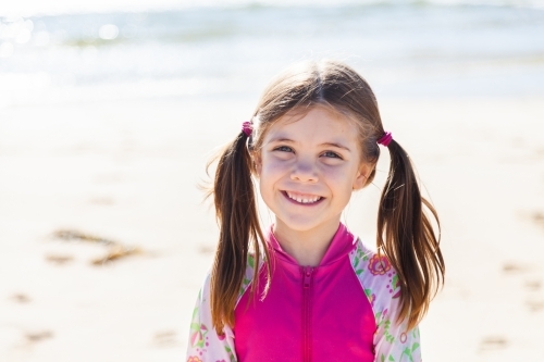 Happy smiling little girl on the beach - Australian Stock Image