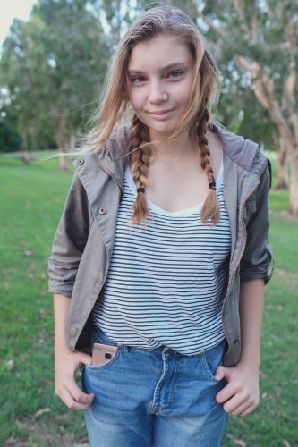 Happy teenage girl in the park - Australian Stock Image