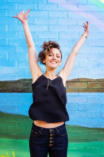 happy woman jumping - Australian Stock Image