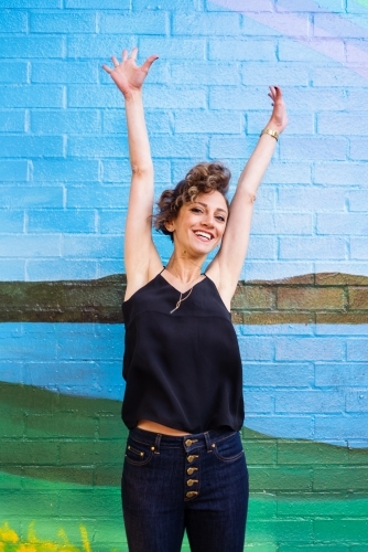 happy woman jumping - Australian Stock Image