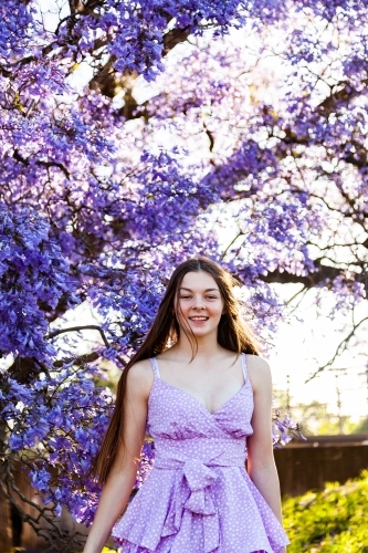 Happy young teen in a purple dress - Australian Stock Image