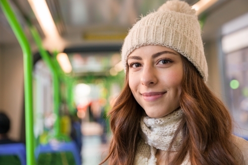 Happy Young Woman On the Tram in Winter - Australian Stock Image