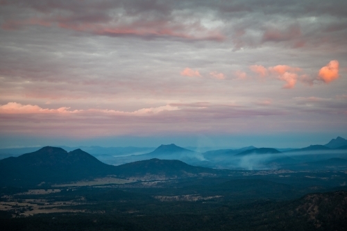 Hazy mountainous landscape under the cloudy sky. - Australian Stock Image