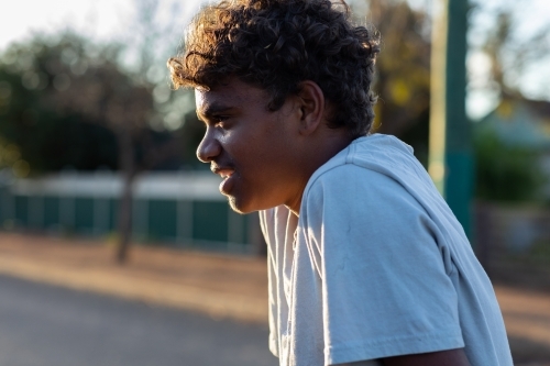 head and shoulders of aboriginal boy in profile - Australian Stock Image