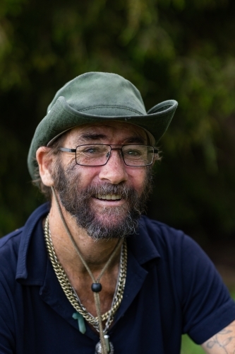 Image of happy older man wearing bucket hat and work clothes - Austockphoto