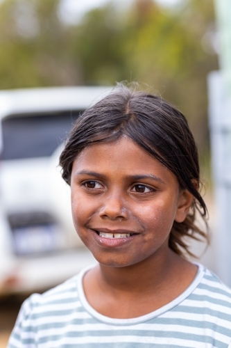 head and shoulders of young noongar girl with traces of white zinc left on her face - Australian Stock Image