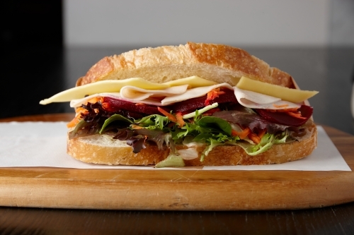 Healthy ham, cheese and salad sandwich on board - Australian Stock Image