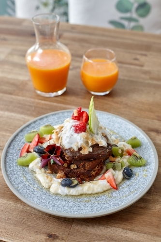 Healthy organic vegan food and drinks on wooden table - Australian Stock Image