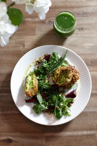 Healthy vegetarian falafel and salad dish on wooden table - Australian Stock Image