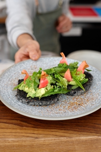 Healthy vegetarian meal being served on table - Australian Stock Image