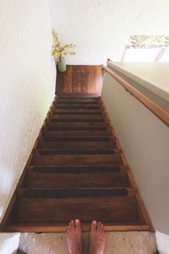 High angle shot of stairwell with feet at the top - Australian Stock Image