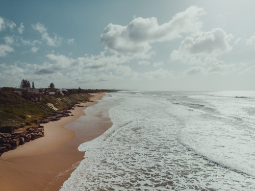 High angle shot of waves crashing on a deserted beach - Australian Stock Image