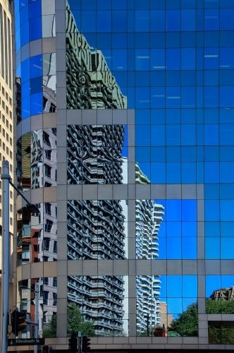 High-rise buildings in Elizabeth Street, Sydney, reflected in glass of adjacent buildings - Australian Stock Image