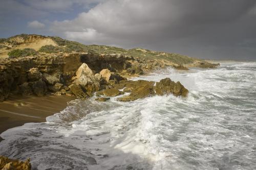 High tide waves crashing on the beach and rocks - Australian Stock Image