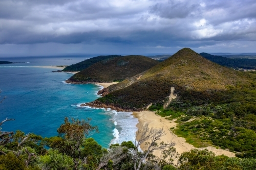 High view of beach and mountain with moody sky - Australian Stock Image