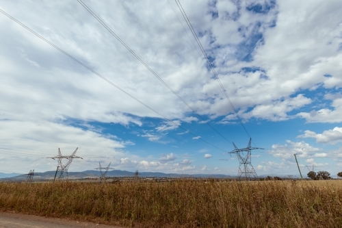 High voltage power lines in paddock near Tamworth, New South Wales - Australian Stock Image