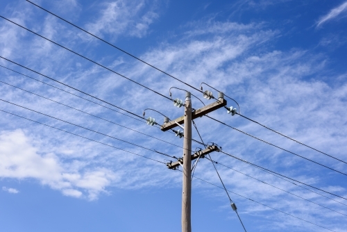 High voltage power transmission tower on blue sky background,  electricity distribution. - Australian Stock Image