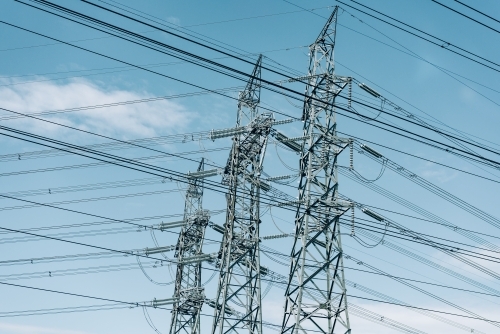 High voltage power transmission tower on blue sky background,  electricity distribution. - Australian Stock Image