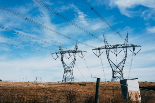 High voltage power transmission tower on blue sky background,  electricity distribution. - Australian Stock Image