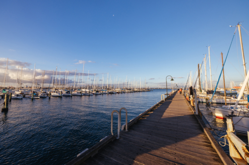 Hobsons Bay around Ferguson St Pier in Williamstown waterfront at dusk in winter in Victoria - Australian Stock Image