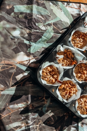 Homemade apple crumble muffins in muffin tin - Australian Stock Image