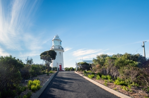 Horizontal shot of a lighthouse under blue and white skies - Australian Stock Image