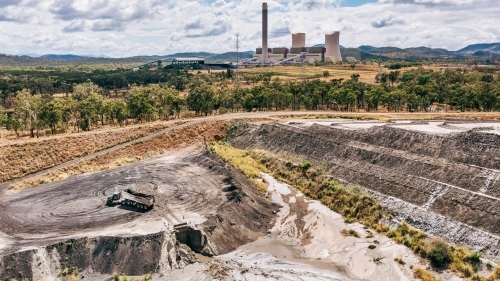 Horizontal shot of a tipper truck near Stanwell power station and ash piles - Australian Stock Image