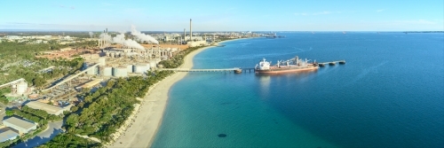 Panoramic shot of Kwinana alumina refinery on a sunny day with industrial plant and docked ship - Australian Stock Image