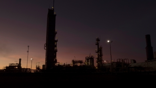 Horizontal shot of an industrial plant after sunset - Australian Stock Image