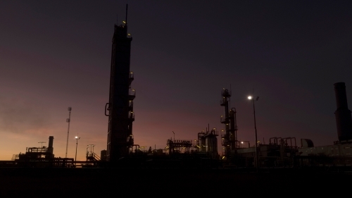 Horizontal shot of an industrial plant at dawn/night - Australian Stock Image