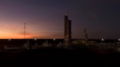 Horizontal shot of an industrial plant at sunset - Australian Stock Image