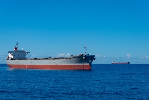 Horizontal shot of cargo ships at Coral Sea - Australian Stock Image