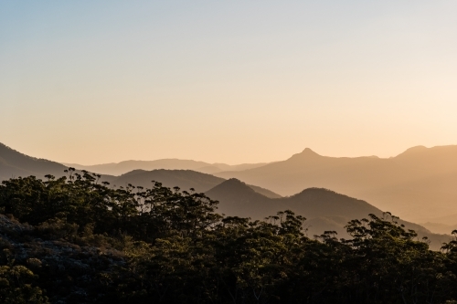 Horizontal shot of mountain ranges at sunset - Australian Stock Image