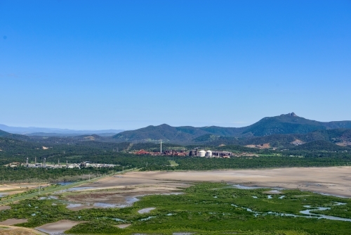 Horizontal shot of mudflats and industrial sites near Gladstone - Australian Stock Image