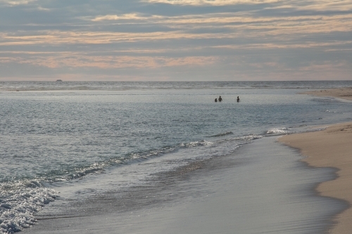 Horizontal shot of sea shore at sunset. - Australian Stock Image