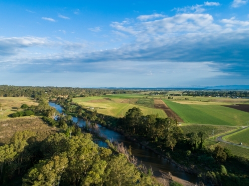 Hunter River running past fertile Australian farmland river flats in summer - Australian Stock Image