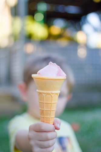 Ice cream being held by small boy - Australian Stock Image