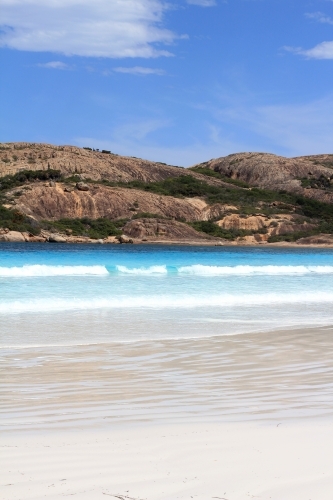View across ocean towards granite hills - Australian Stock Image