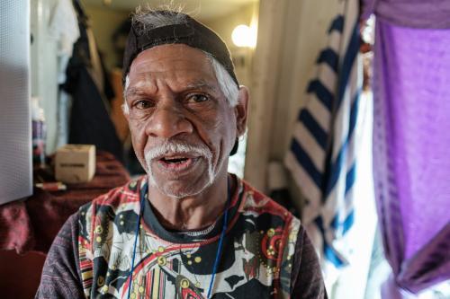 Indigenous Australian Man with white mustache sitting indoors - Australian Stock Image