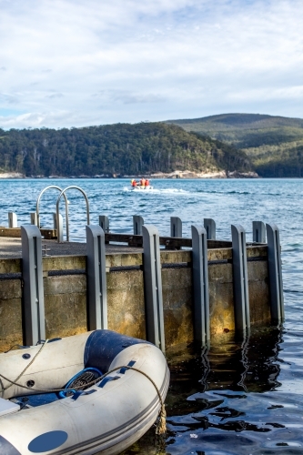 Inflatable dinghy beside a jetty - Australian Stock Image