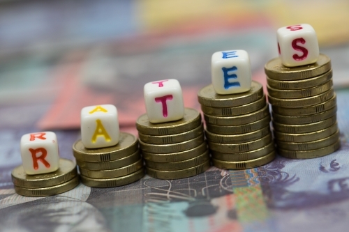 Inflation and the Rise of Interest Rates concept with coins and word - Australian Stock Image