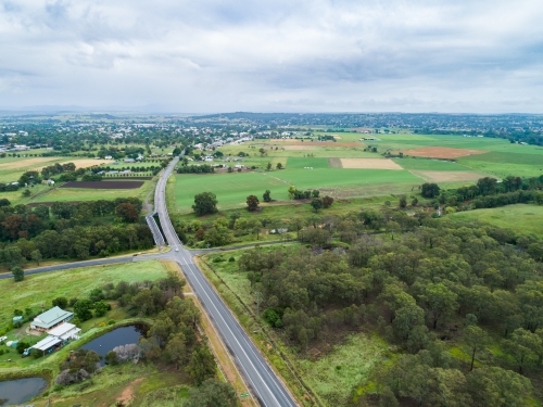 Intersection of country roads going to bridge towards town of Singleton - Australian Stock Image